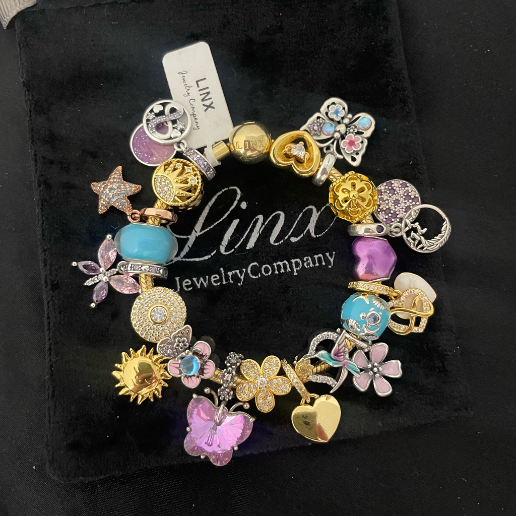 Linx Yellow Gold Snake Chain Bracelet With Gold Purple Pink And Blue Charms